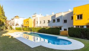 a swimming pool in a yard next to a building at Spacious family friendly 3 bedroom home B' Pueblo - swimming pool - games room & sunny terrasse in Benalmádena