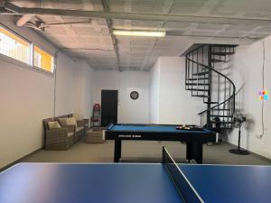 a room with a ping pong table and a staircase at Spacious family friendly 3 bedroom home B' Pueblo - swimming pool - games room & sunny terrasse in Benalmádena