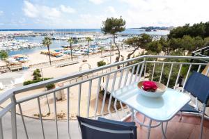 a table and chairs on a balcony with a view of a harbor at Vivalidays Joan - Blanes in Blanes