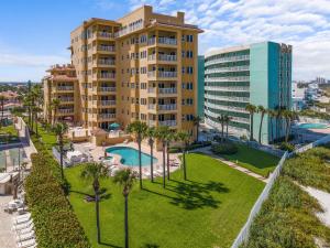 an aerial view of a resort with a pool and palm trees at Atlantic Villas 402 in New Smyrna Beach