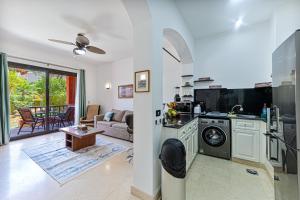 a kitchen and living room with a washer and dryer at Beautiful apartment with terrace to the pool in Hurghada +3 photos