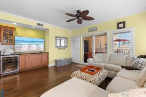 a living room with a couch and a flat screen tv at Atlantic Villas 103 in New Smyrna Beach