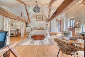 a bedroom with a bed and a living room at Les Jardins d'Ortigia - Confort in Dourgne