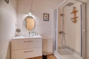 a white bathroom with a sink and a shower at Les Jardins d'Ortigia - Confort in Dourgne +20 photos