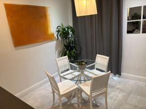 a dining room with a glass table and chairs at Knickerbocker 102 in Miami Beach