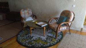 a living room with two chairs and a table at Chez Corban in Rosans