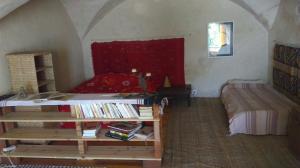 a bedroom with a bed and a table with books at Chez Corban in Rosans