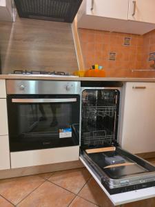 an oven with its door open in a kitchen at Relax Terrace apartment with Jacuzzi in Brela +6 photos
