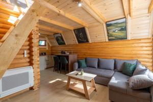 a living room with a couch in a log cabin at Wood heaven in Žabljak