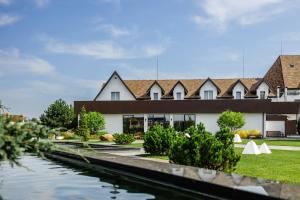 a building with a canal in front of it at Aivengo Hotel in Rivne