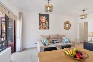 a living room with a table with a bowl of fruit on it at Orion Beach in Puerto