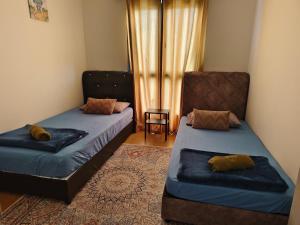 a bedroom with two beds and a window at Maya Bay Residence Splashmania Gamuda Cove in Banting
