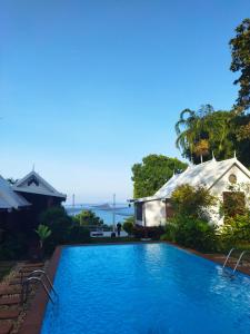 a swimming pool in front of a house at NATUR - Krabi Campsite Glamping & Camping in Krabi town