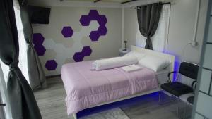 a bedroom with a pink bed and a chair at The Rendezvous Phangan in Ko Phangan