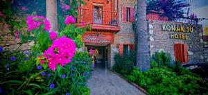 a building with pink flowers and a hotel at Konak Su Hotel in Dalyan