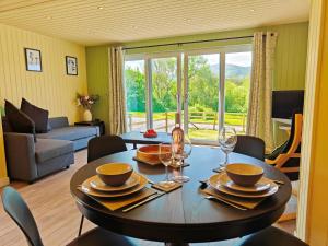a dining room with a table and chairs and a living room at 1 Bed in Conwy 95098 in Llangelynin