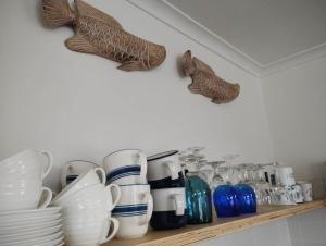 a shelf with a bunch of dishes and shoes on it at Nautical Nest in Bluff
