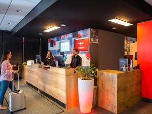 a group of people at a counter in an office at ibis Hotel München City in Munich