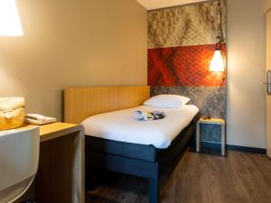 鲁汶宜必思勒芬中心酒店的一间设有一张床的客房,墙上挂着一幅画 更多37张照片