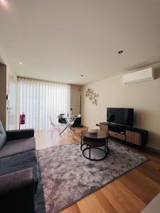 a living room with a couch and a table at Morgado Granja Luxury Suits in Aveiro