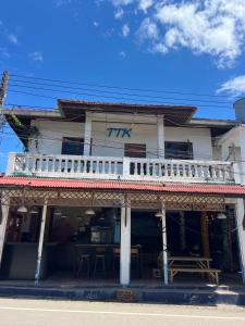 a white building with a balcony on a street at Revolution Pai In Town in Pai