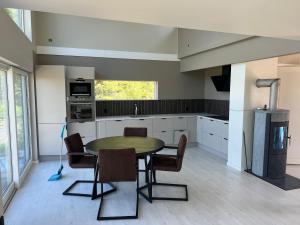 a kitchen with a table and chairs in a room at Stugan in Kristinehamn