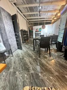 a room with a table and chairs in it at L&K Hostel in Toshkent-Passajir Bekati +3 photos