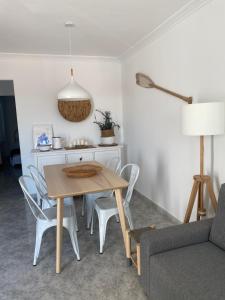a dining room table and chairs in a living room at Can Sesé in Cala en Blanes