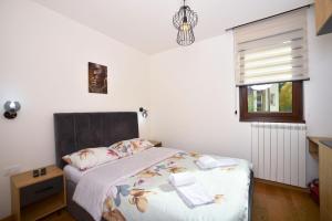 Ένα ή περισσότερα κρεβάτια σε δωμάτιο στο Vila Mina