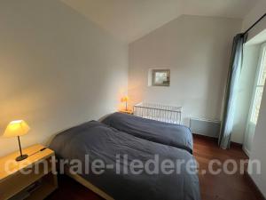 a small bedroom with a bed and a window at La Villa de Hurlevent in Les Portes