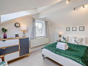 a bedroom with a large bed and a window at 4 Bed in Cartmel LCC71 in Cartmel
