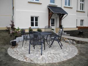 a patio with a table and chairs in front of a house at Castle Mona Diestel GM 69176 in Graal