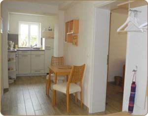 a kitchen with a table and chairs in a room at Castle Mona Diestel GM 69176 in Graal