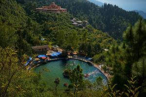 a large pool of water with people in it at Hotel Shiva Lake - Near Mussoorie Lake in Mussoorie