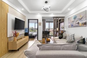 a living room with a couch and a tv at Lavish condo in Nairobi
