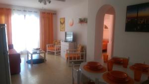 a living room with a table and chairs and a living room at Carabela in Port d'Alcudia