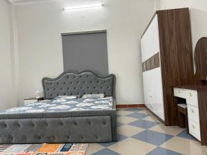 a bedroom with a bed and a dresser and a mirror at TH Homestay in Da Nang