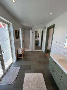 a large bathroom with a sink and a shower at Guest wing at Ginkelösa Nygården in Linköping +12 photos