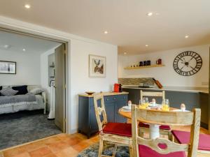 a kitchen and living room with a table and chairs at 1 Bed in Burnham Market 88221 in Burnham Market