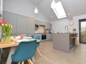 Doddingtonにある2 bed in Lincoln 53878のキッチン(ダイニングテーブル、青い椅子付)