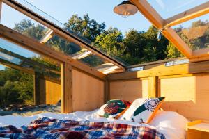 a bedroom in a tree house with a bed at Wild Orchard Farm in San Costantino Albanese