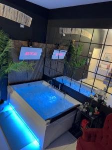 a large hot tub in a room with aperature at AMA Esclusive SPA Madama in Ferrara