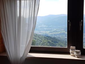 a window with a view of a mountain view at Ferienhaus im Bayerischen Wald in Schöfweg