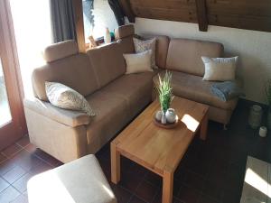 a living room with a couch and a coffee table at Ferienhaus im Bayerischen Wald in Schöfweg +32 photos