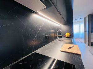 a kitchen with a counter with a cutting board on it at Granja Premium House in Aveiro