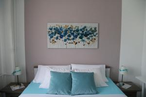 a bedroom with a bed with blue and white pillows at Joop Apartment in Zagreb