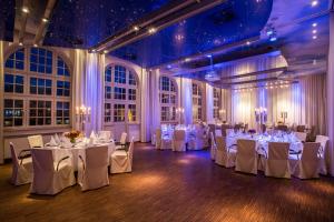 a banquet hall with white tables and white chairs at Mintrops Stadt Hotel Margarethenhöhe in Essen