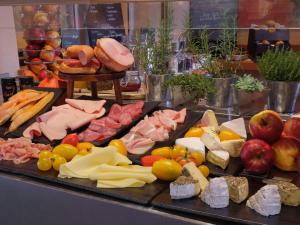 a display of different types of meats and cheese at Mintrops Stadt Hotel Margarethenhöhe in Essen