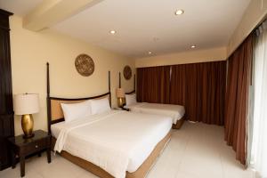 a hotel room with two beds and a window at Sunday Chateau En Ville - Pattaya in Pattaya North +87 photos