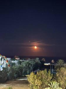 a view of the moon over the ocean at night at Lovely 1-bedroom rental unit with sea view 2 in Mahdia